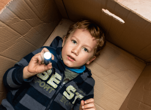 kids playing in cardboard box