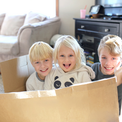 kids playing in a cardboard box.