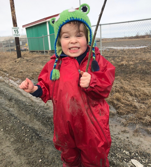 kids outside on a muddy day in a kids rain suit
