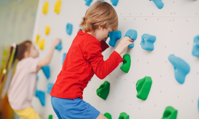 kids rock climbing in the climbing gym