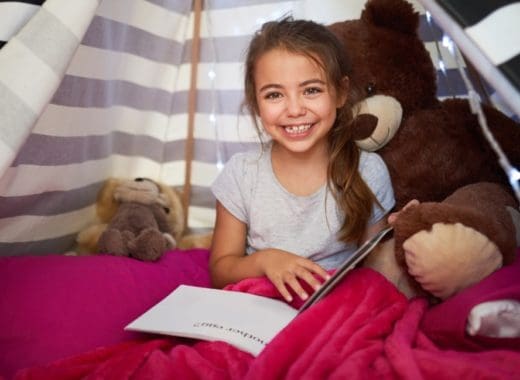 A girl in a kids reading nook.