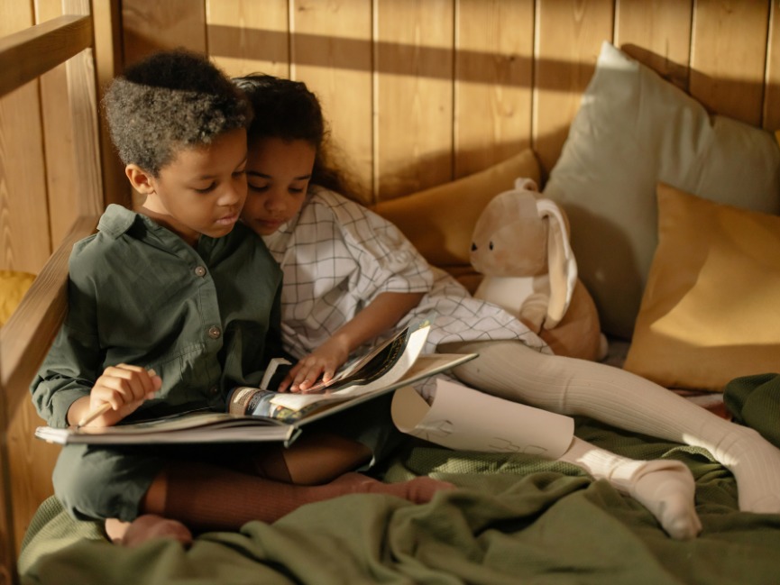 Kids read a book in a kids reading nook.