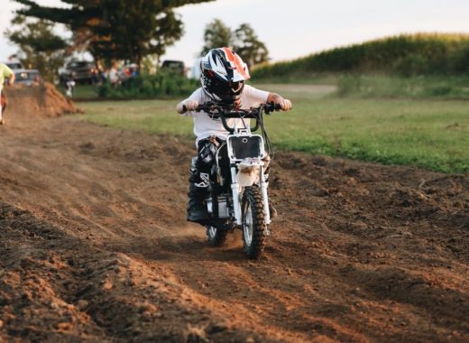 A kid rides an electric dirt bike for kids