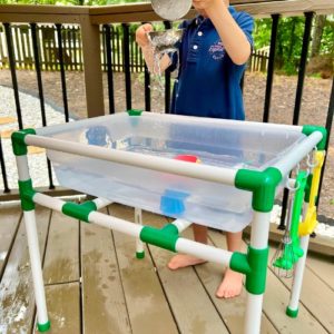 One year old playing in a water table