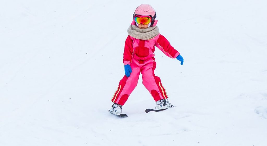 a child wearing a kids ski helmet