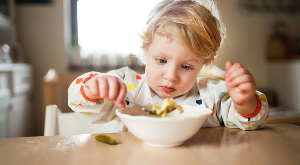 kid eating with a spoon