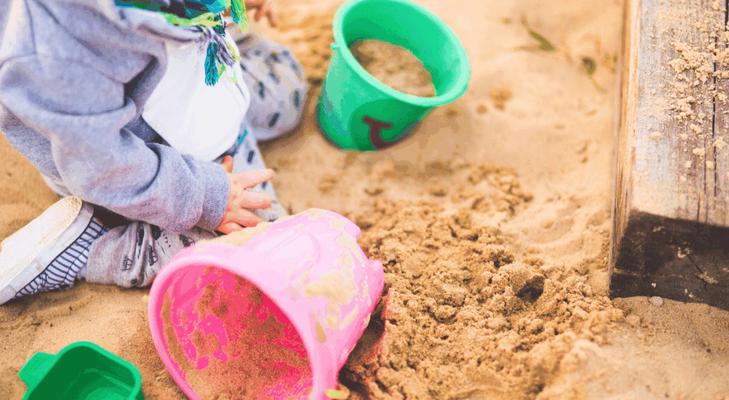 two year old playing in the sandbox