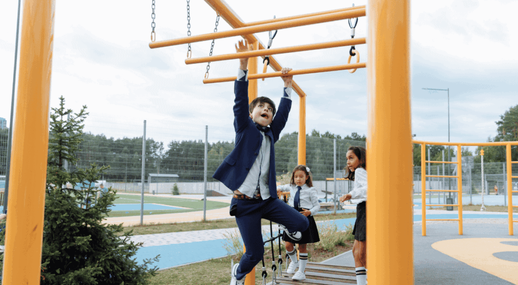 kids swinging on monkey bars