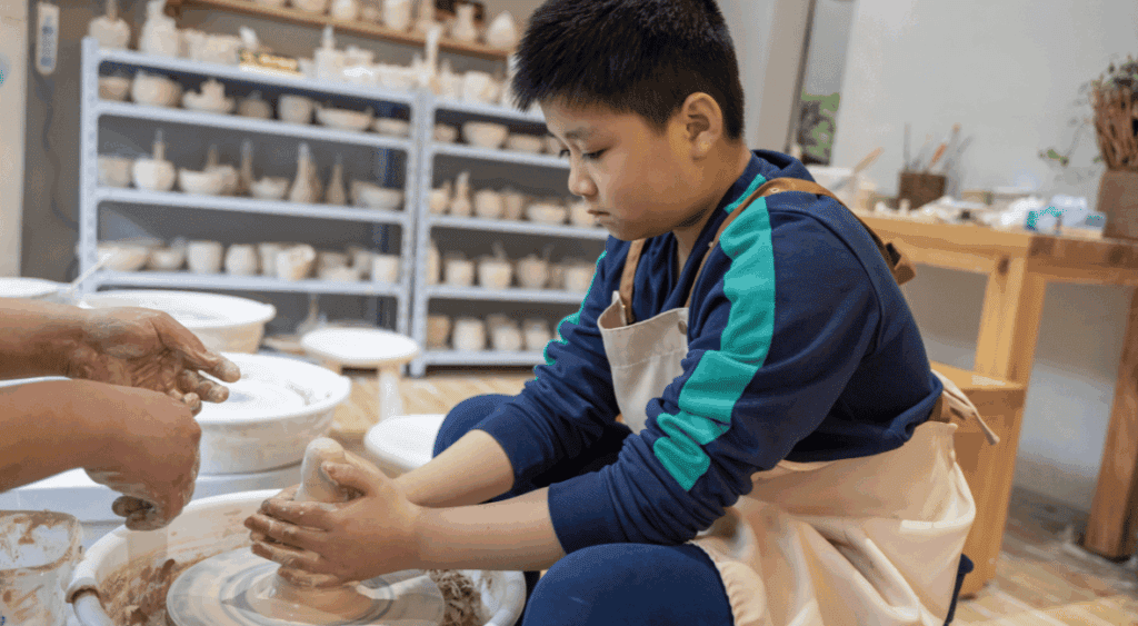 kid making pottery