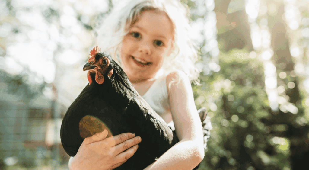 preschooler holding a bird